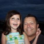 Image description: Annie Cohane laughs with her dad Kevin. Annie was diagnosed with Leber congenital amaurosis (LCA) at 3 months of age. Genetic testing later showed a mutation in her CEP290 gene. 