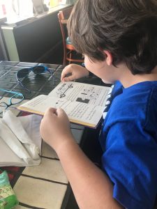 Creed reading the menu at his favorite restaurant, Mount Dora Pizza, without a flashlight or extra lamps.