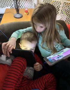 Drew' s sister Anna helping him with his computer