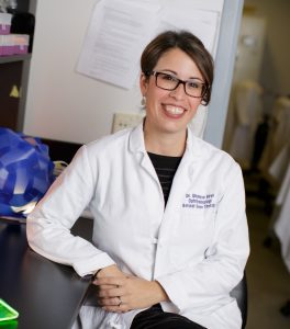 smiling woman in doctor coat