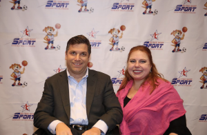 Smiling man on left with smiling woman on right.