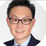 head shot of man wearing glasses